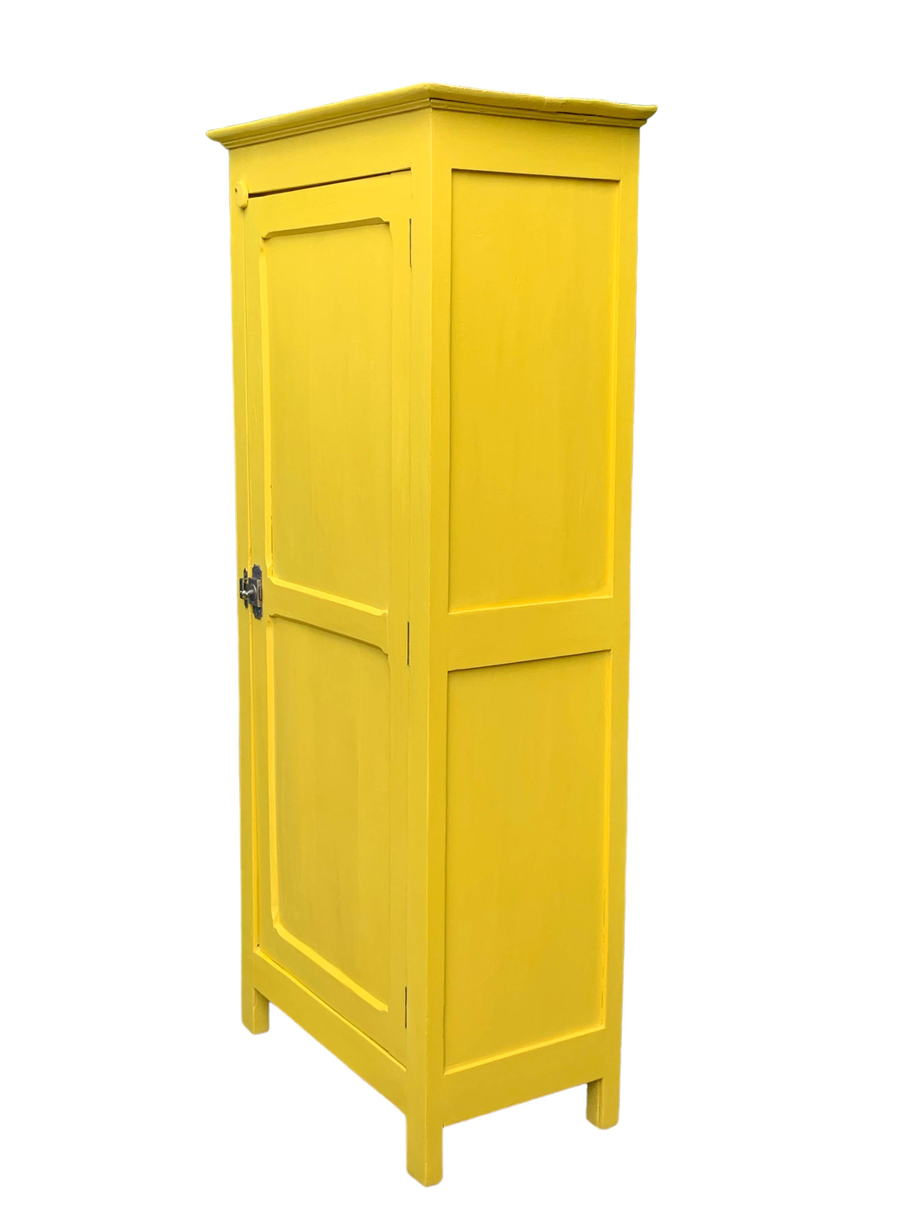 Antique powder yellow Parisian bonnetière wardrobe.