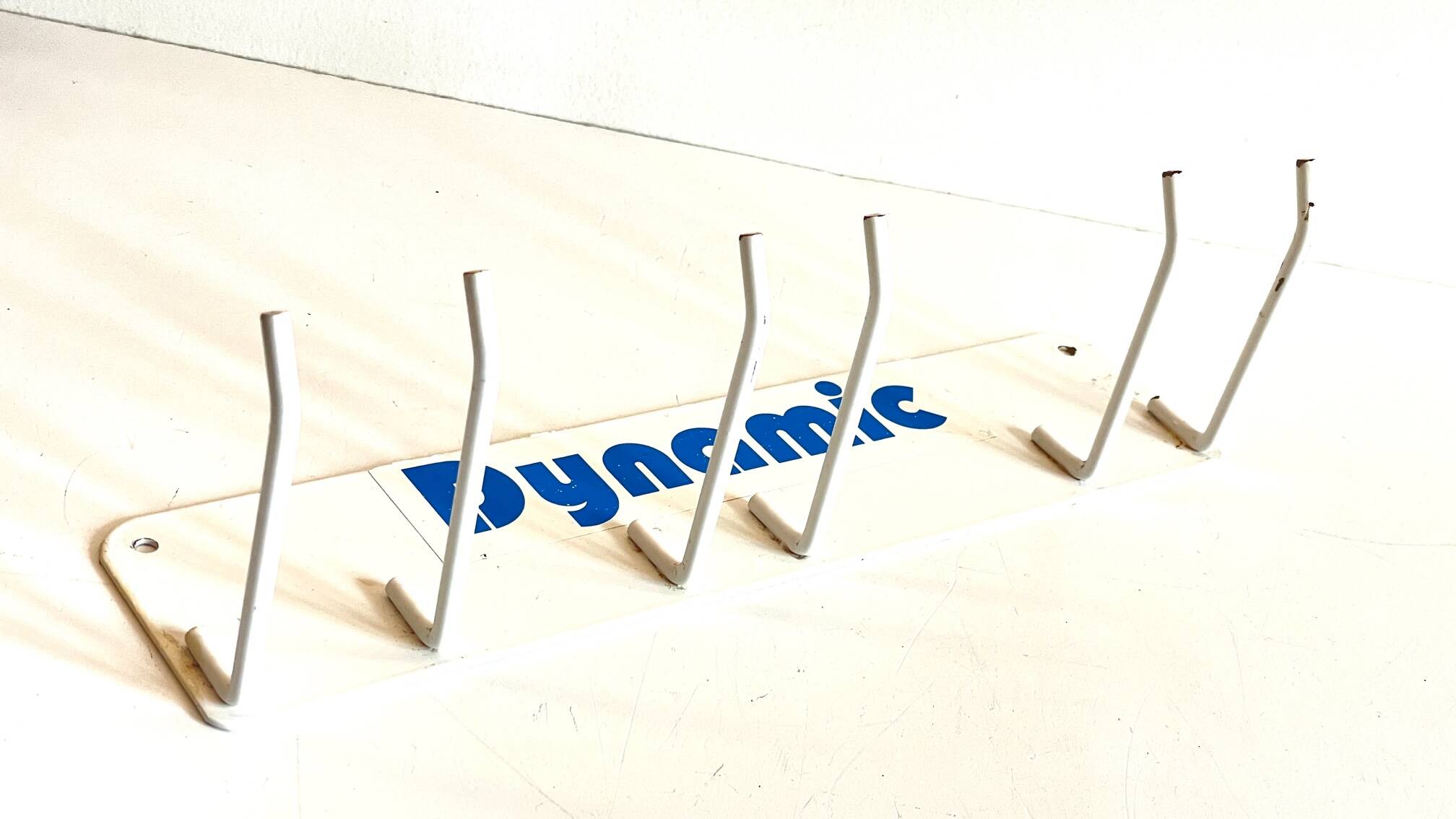 Vintage white metal wall trade coat rack