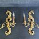 Pair of Italian Hollywood Regency wall lights in iron and gilded sheet metal.