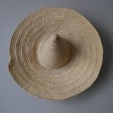 Hand-woven wicker straw hat, artisanal production, decorative object, bohemian ethnic countryside
