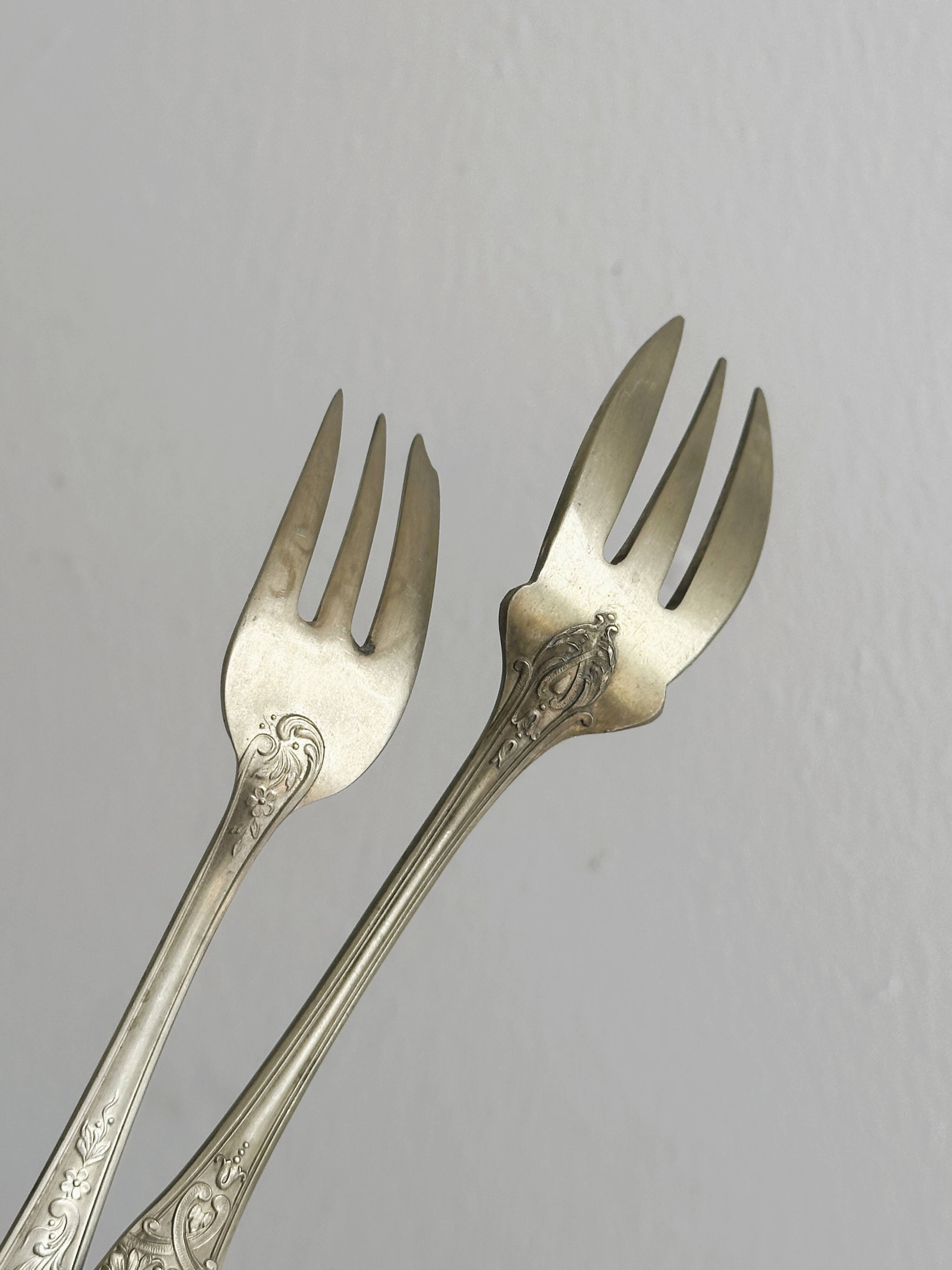 Pair of metal forks, ornate design