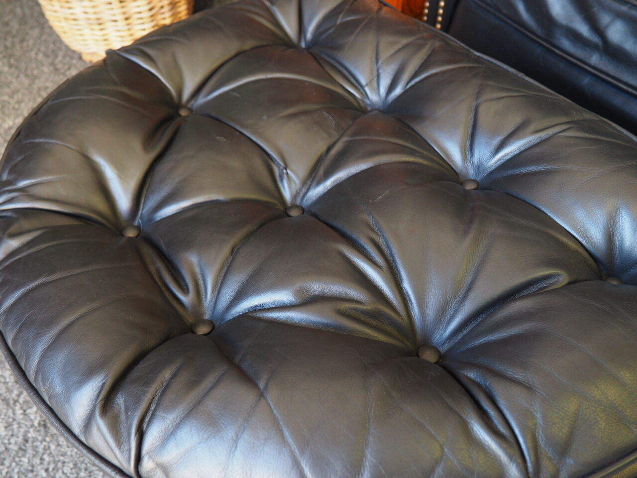 Chesterfield style leather armchair & footstool by Hancock & Moore