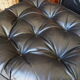 Chesterfield style leather armchair & footstool by Hancock & Moore