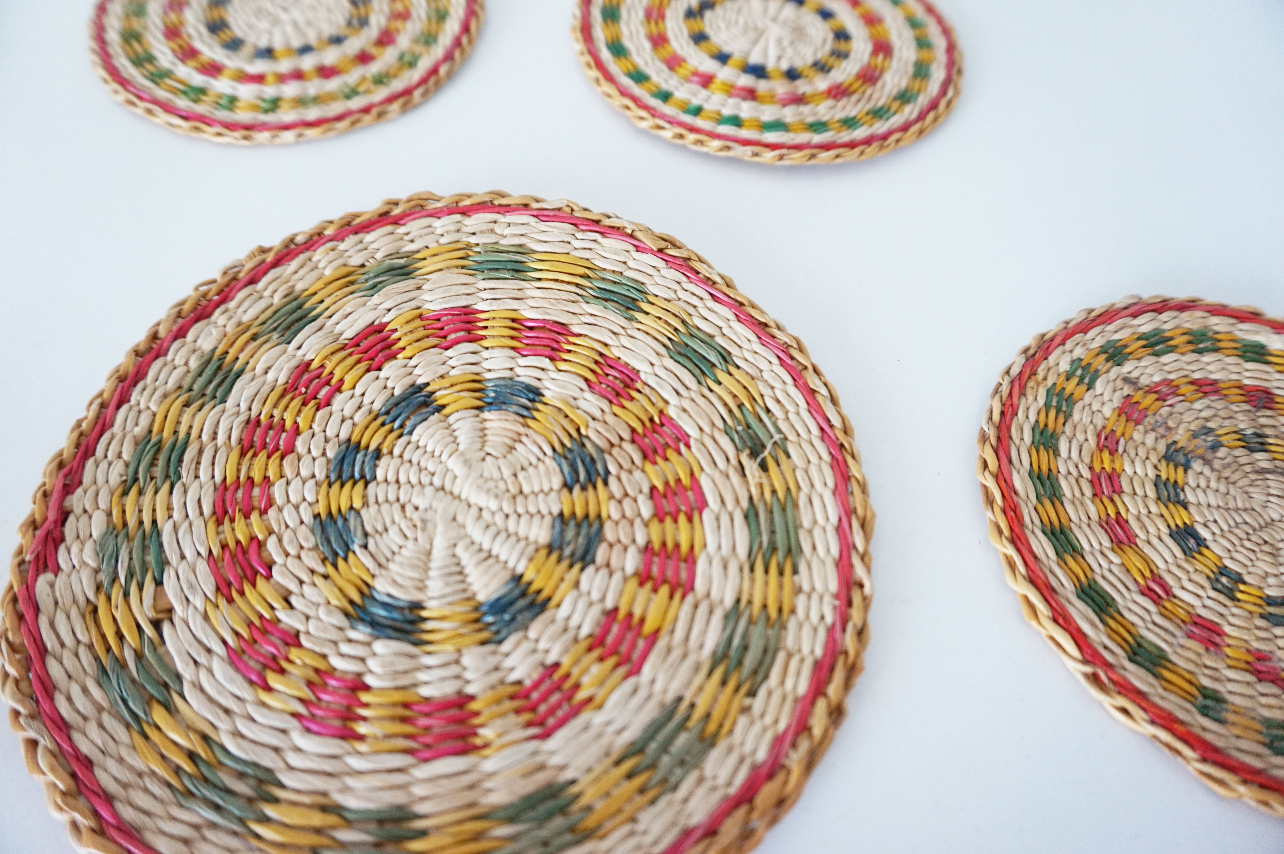 Set of coasters and bottles in colored wicker