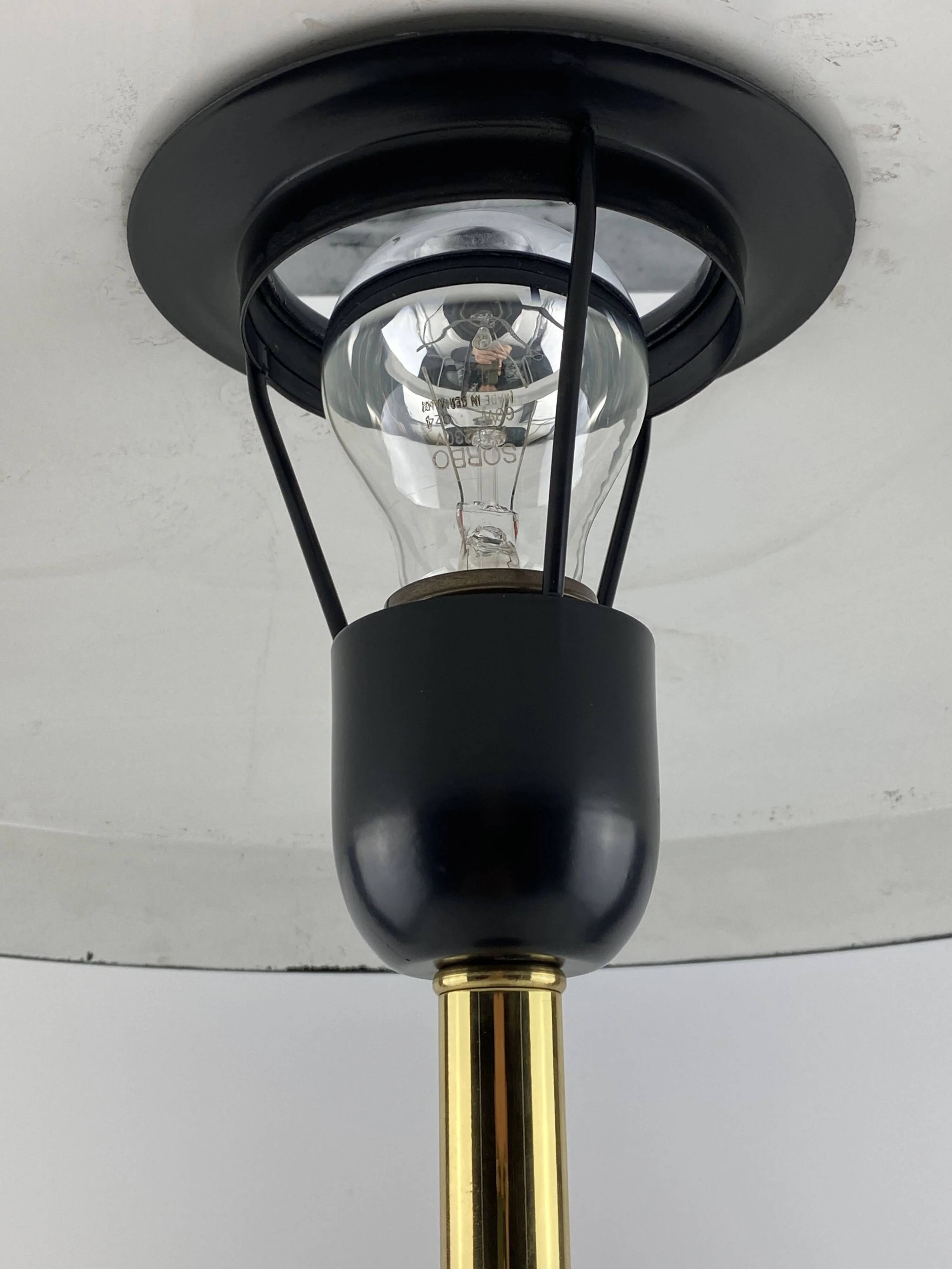 Rare black and gold UFO table lamp by Louis Kalff for Philips.