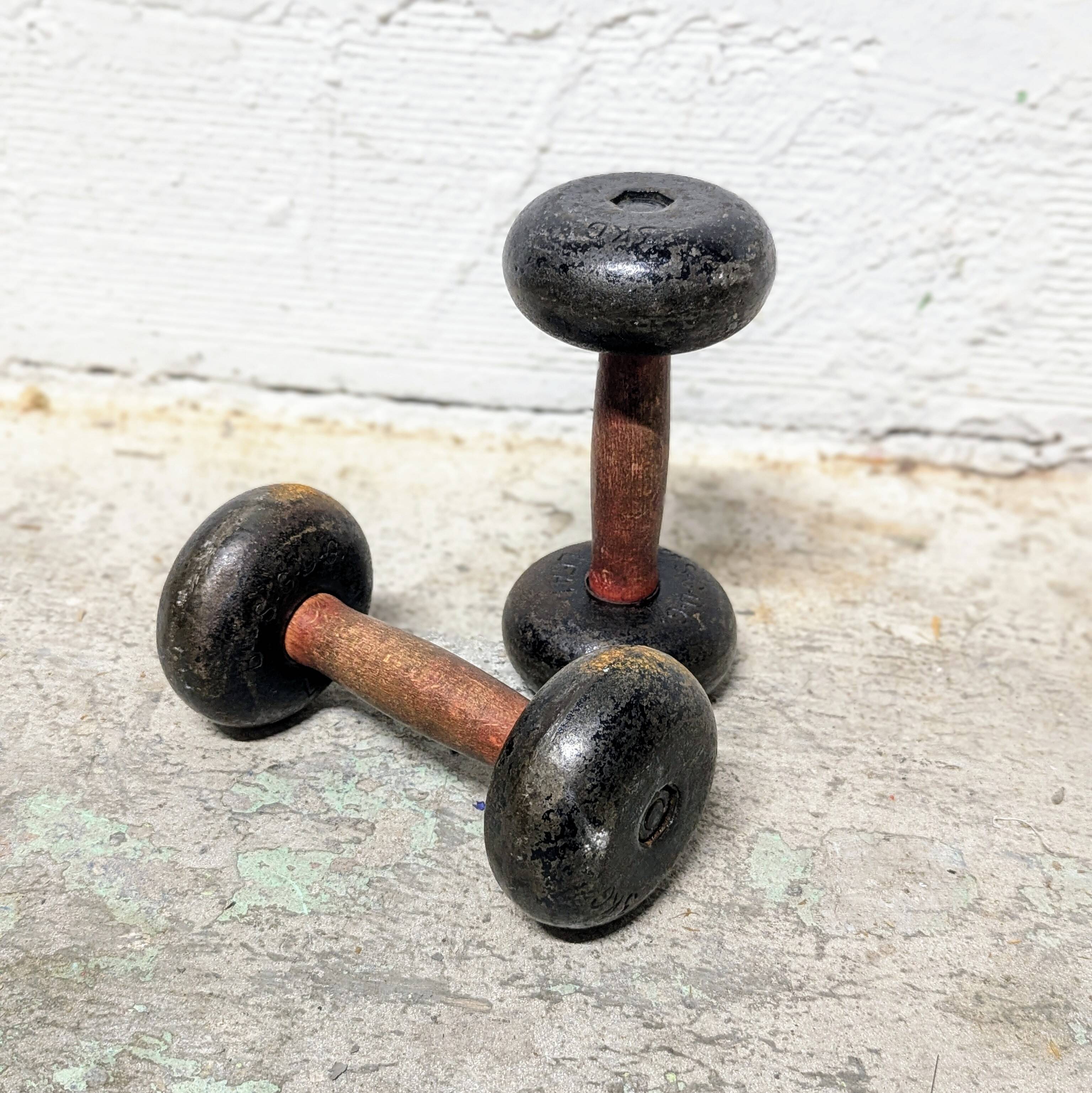 Pair of vintage cast iron and wood dumbbells
