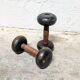 Pair of vintage cast iron and wood dumbbells