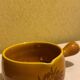 Glazed yellow earthenware fondue pot