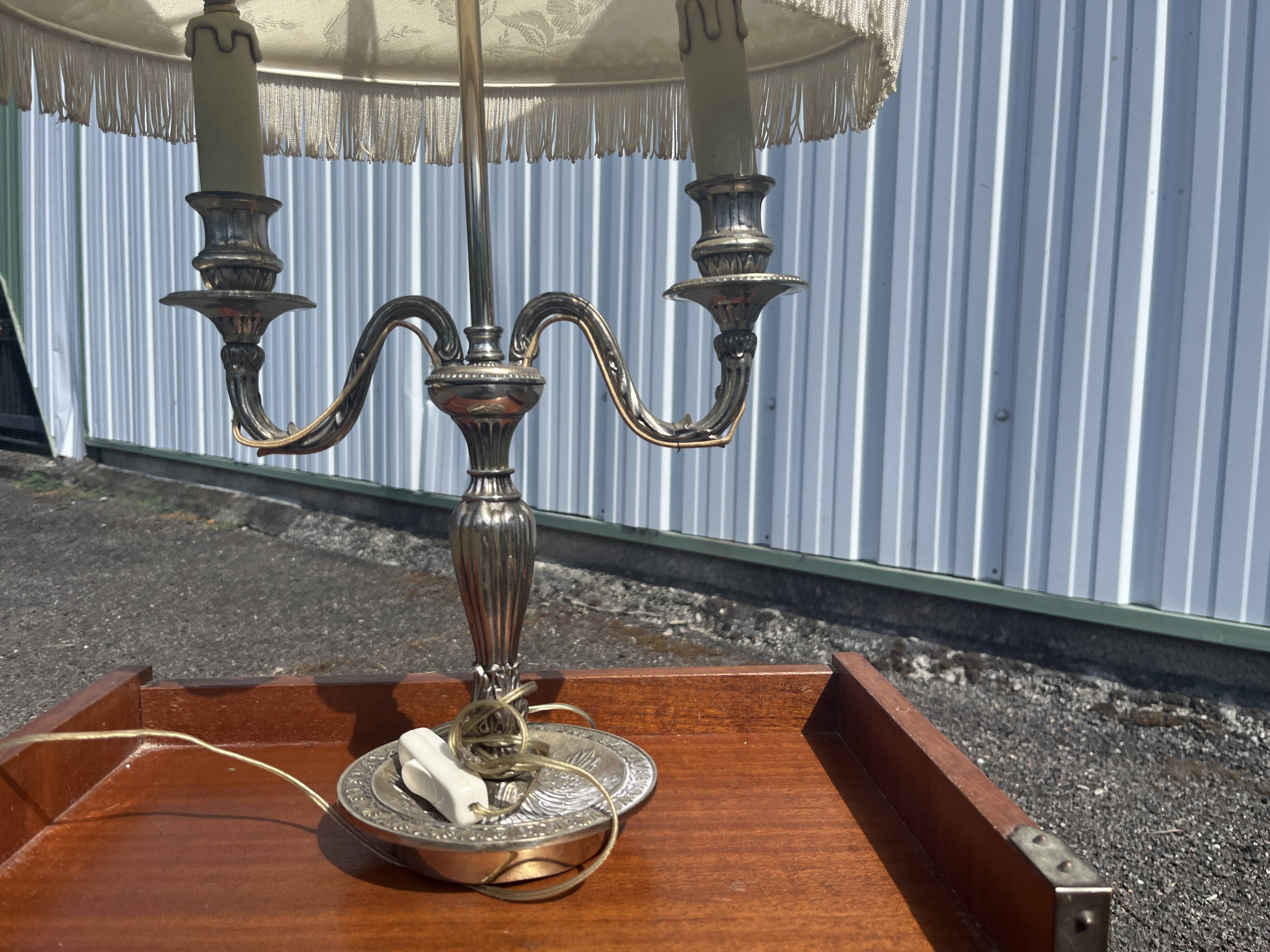 Two-armed hot water bottle lamp in silver metal with fringed fabric shade