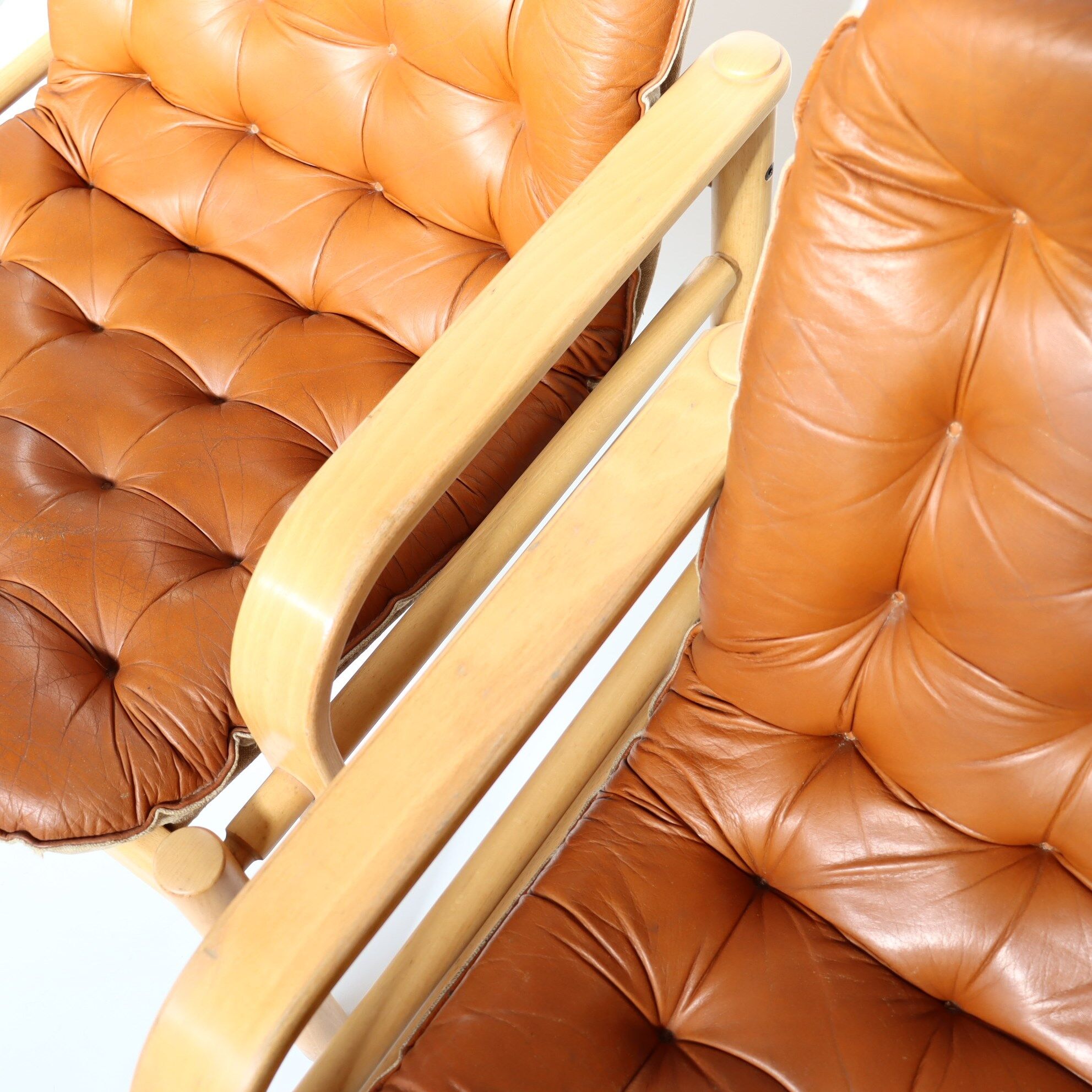 Upholstered leather armchairs 70s