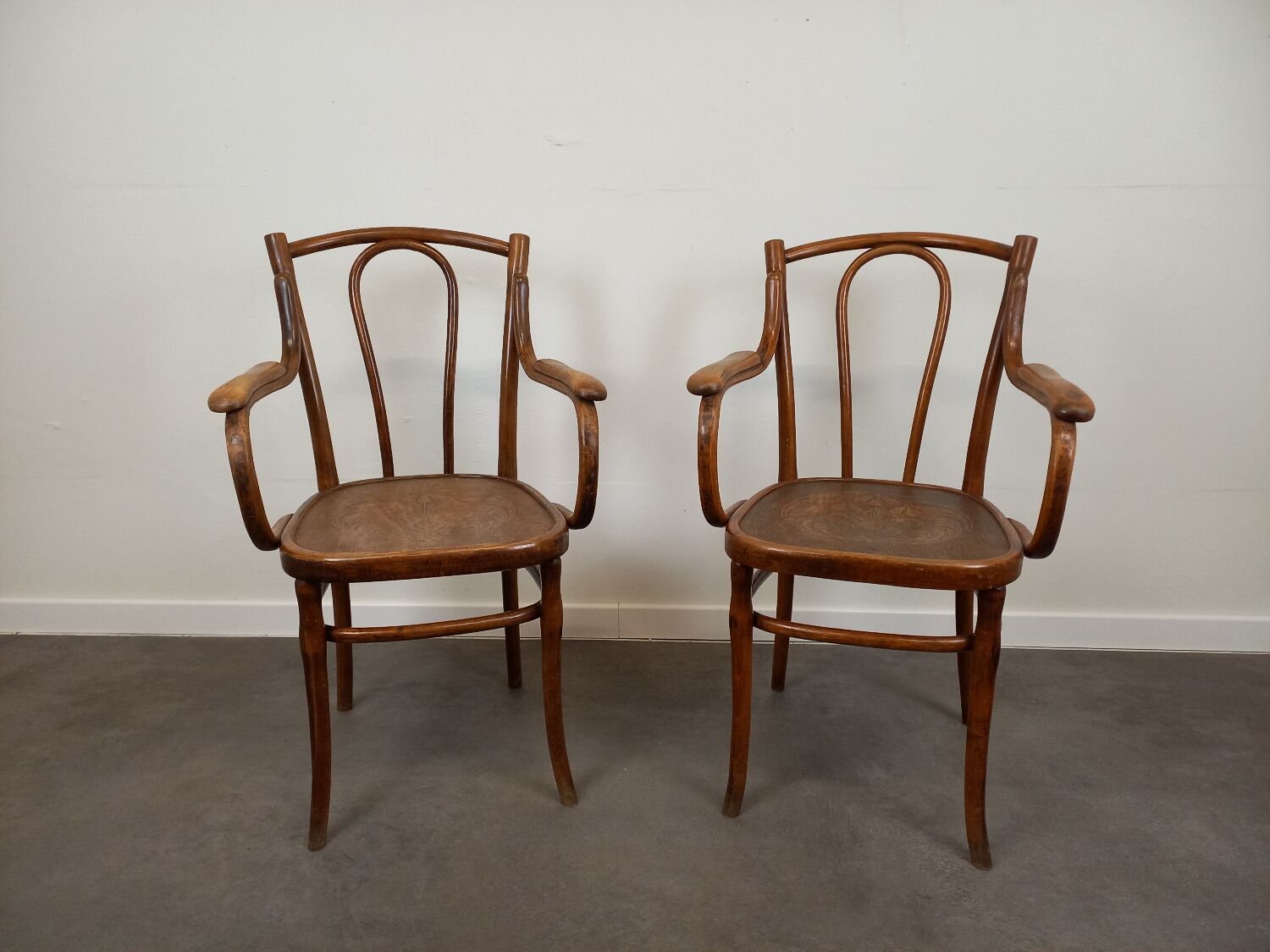 Pair of curved wooden bistro armchairs