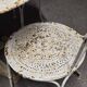 Antique painted wrought iron garden furniture, round table and four chairs.