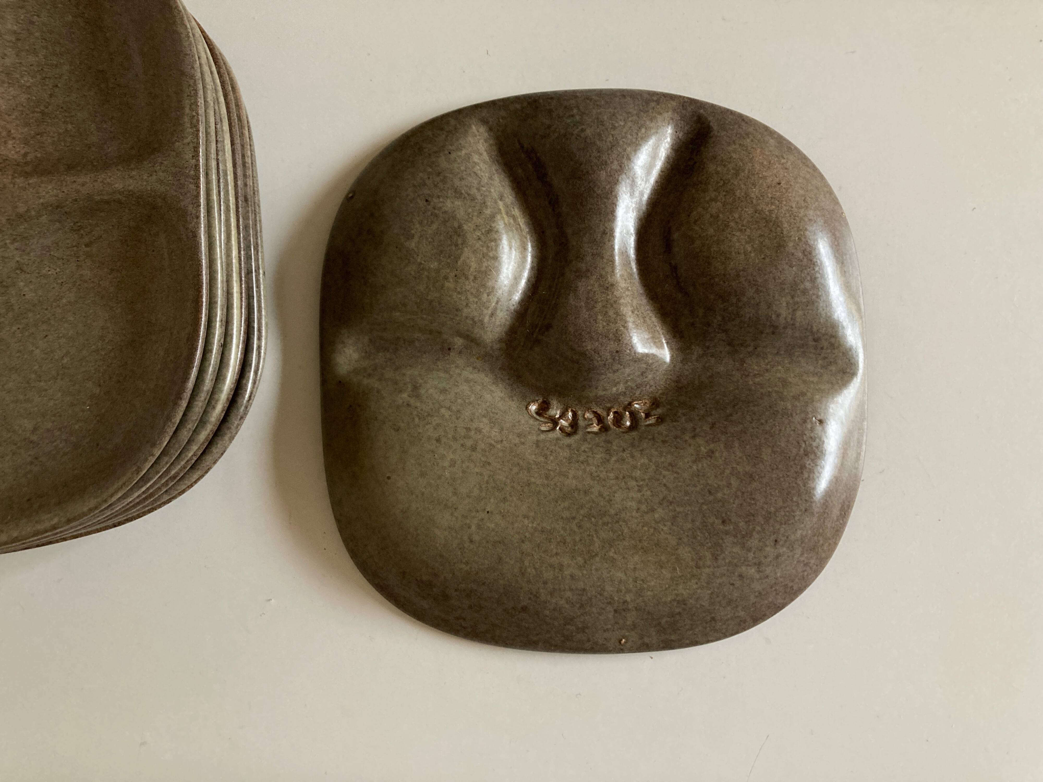 Set of 8 mid century modern stoneware potter's plates to identify