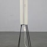 Mid-century modern floor lamp on iron legs with plastic shade and wood accent