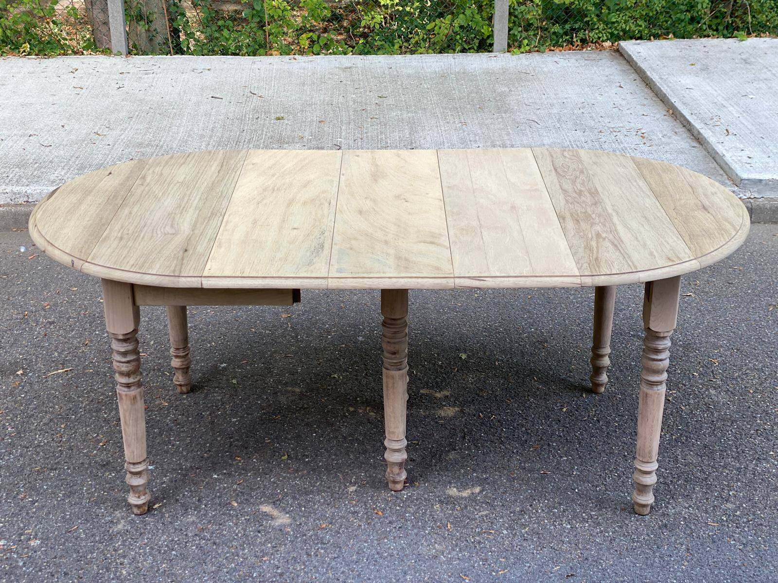 Round extendable dining table with flaps, stripped in raw oak, with 3 extensions.