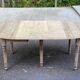 Round extendable dining table with flaps, stripped in raw oak, with 3 extensions.