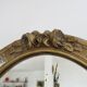 Oval wall mirror, golden floral pattern in stucco and wood, late 19th century