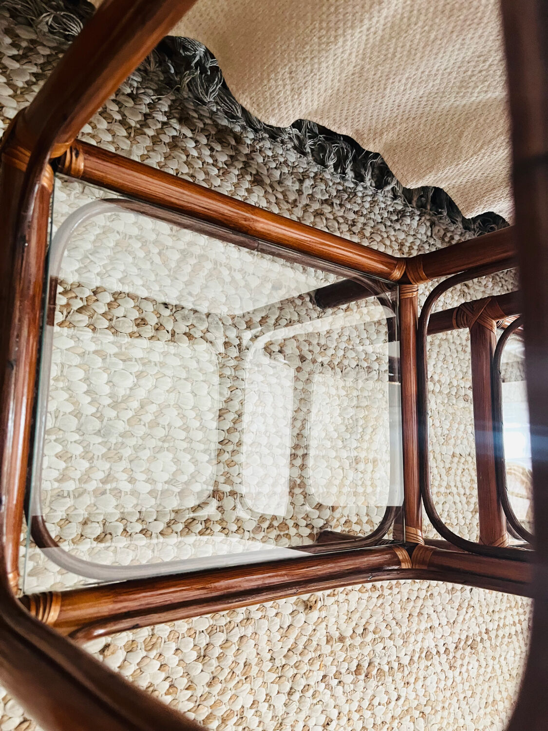 Two rattan and glass bedside tables