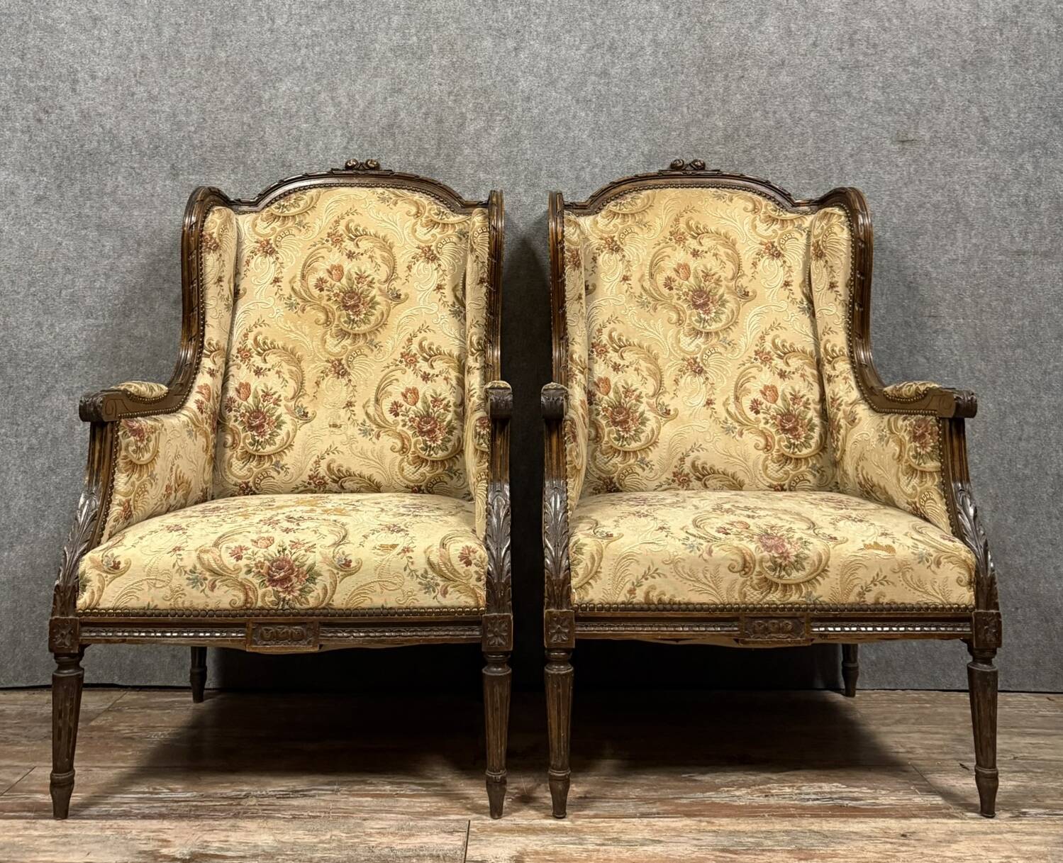 Large pair of Louis XVI style carved wooden wingback armchairs