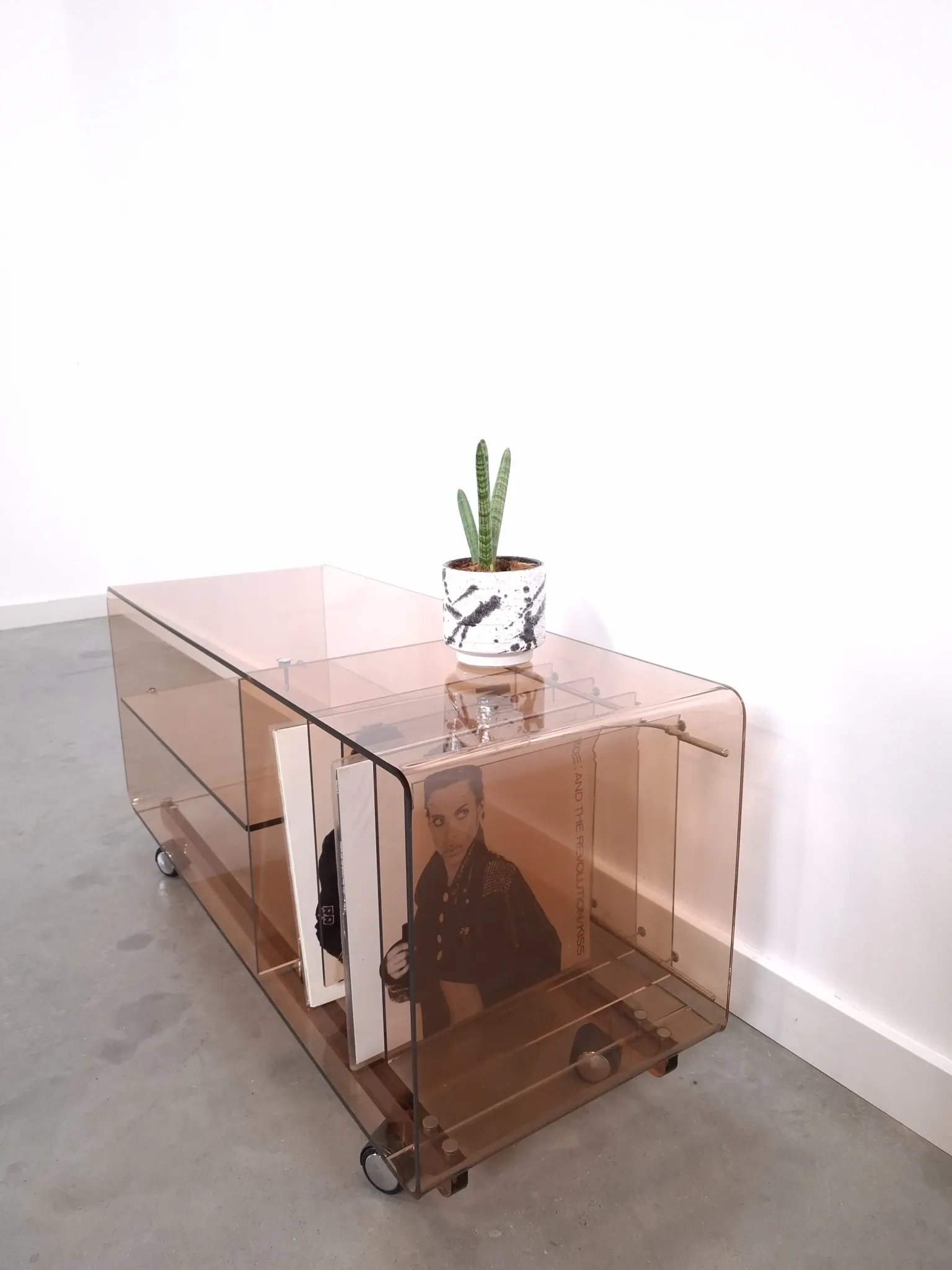 Vintage hifi, LP cabinet, TV unit made of tinted plexiglass on wheels, records.