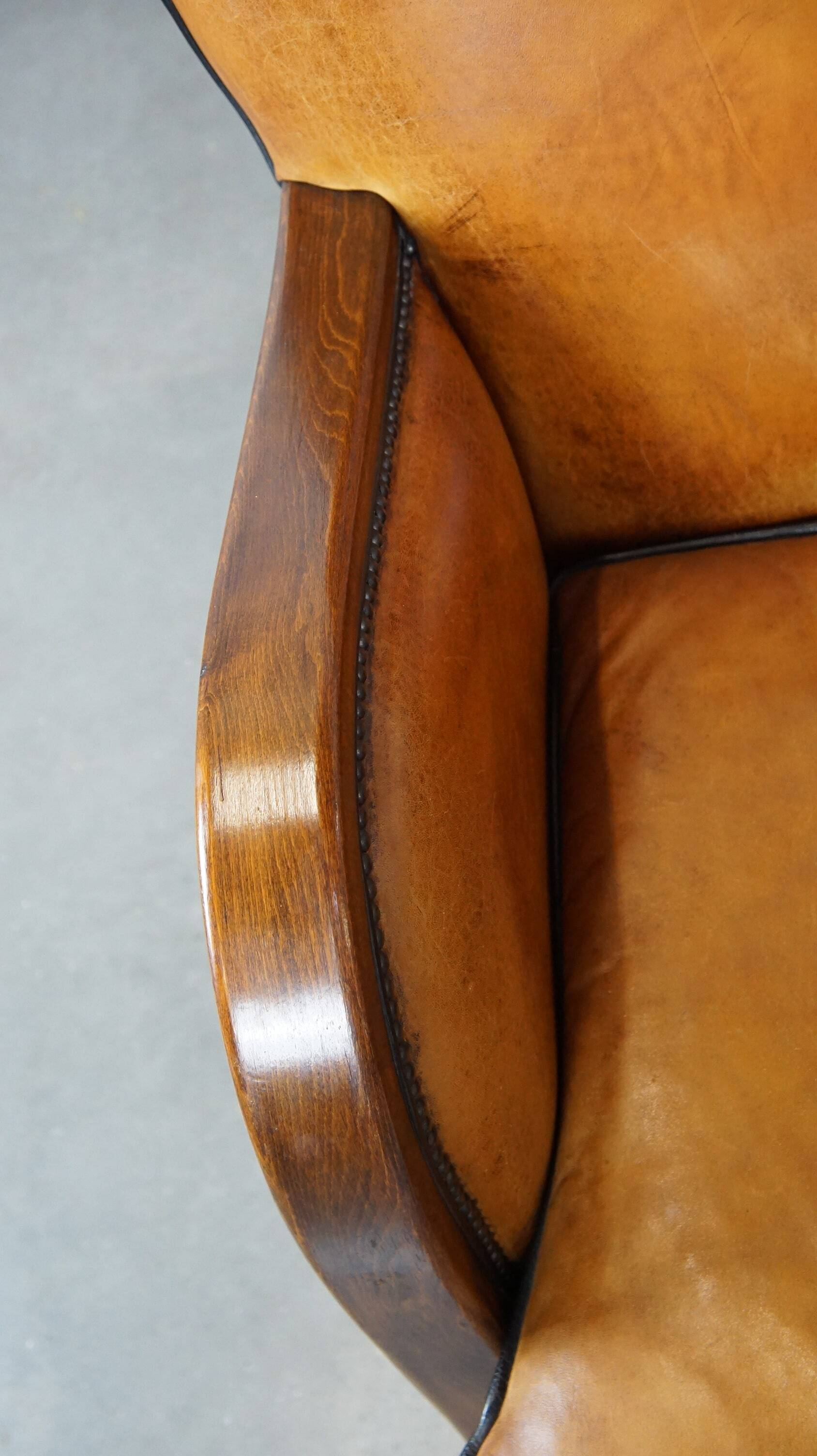 Unique, luxurious sheepskin armchair combined with wood and finished with decorative nails