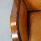 Unique, luxurious sheepskin armchair combined with wood and finished with decorative nails