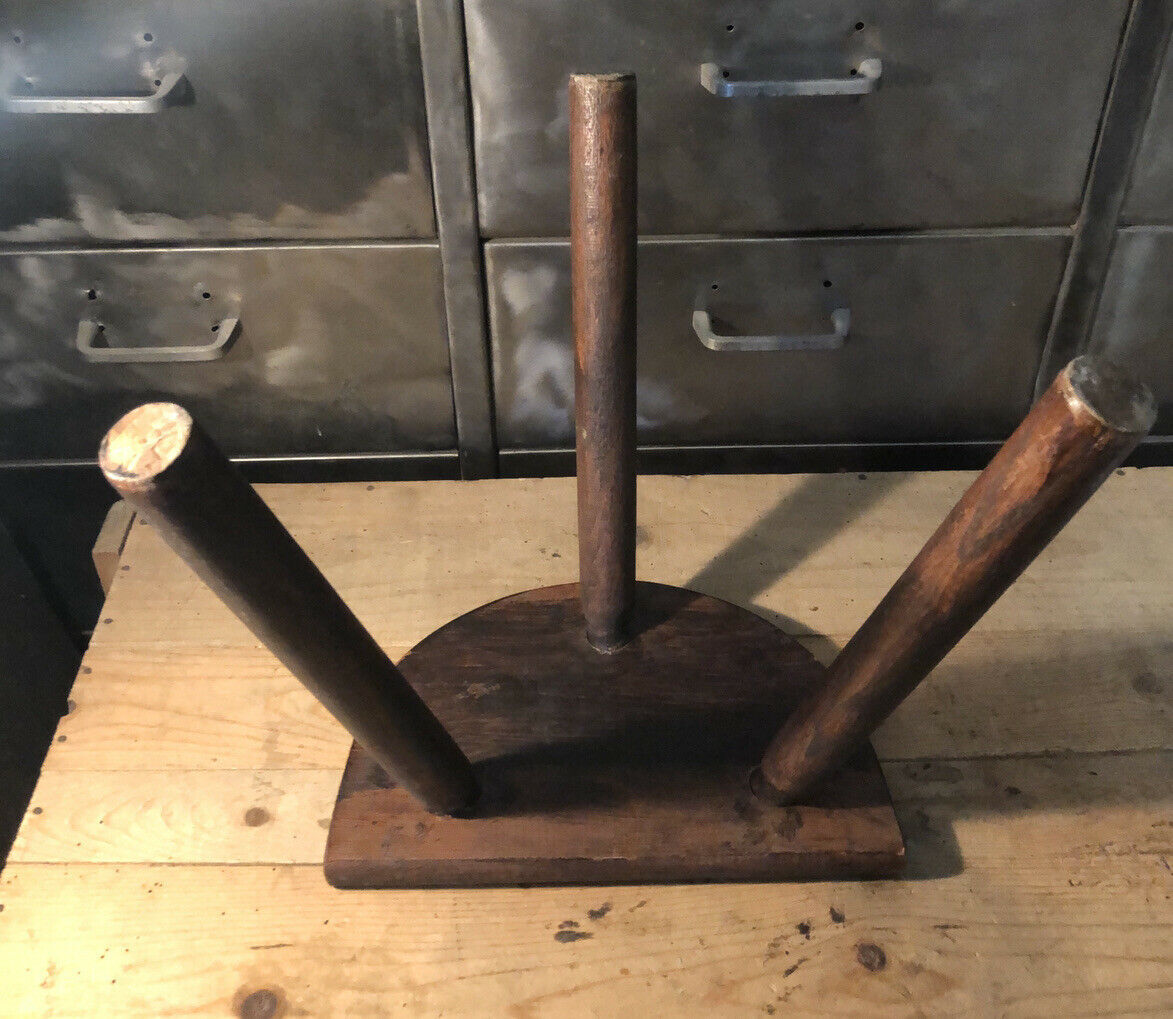 Wooden milking stool on tripod base