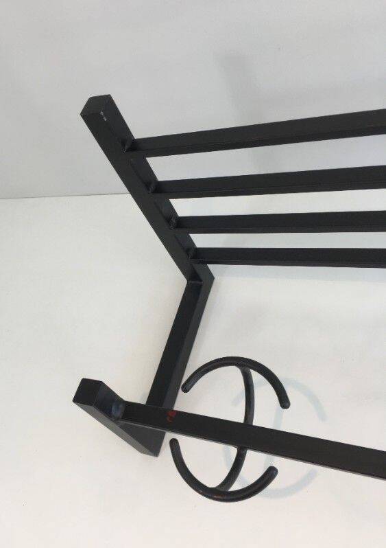 Designer coat rack in blackened metal