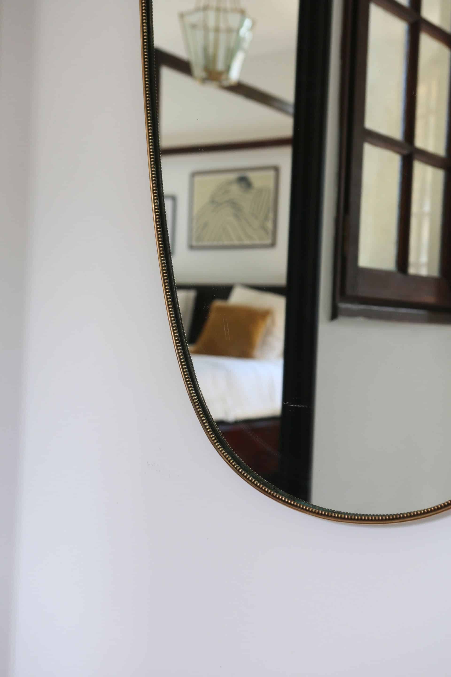 Brass mirror with crest, bead frieze, Italian design style.