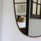 Brass mirror with crest, bead frieze, Italian design style.