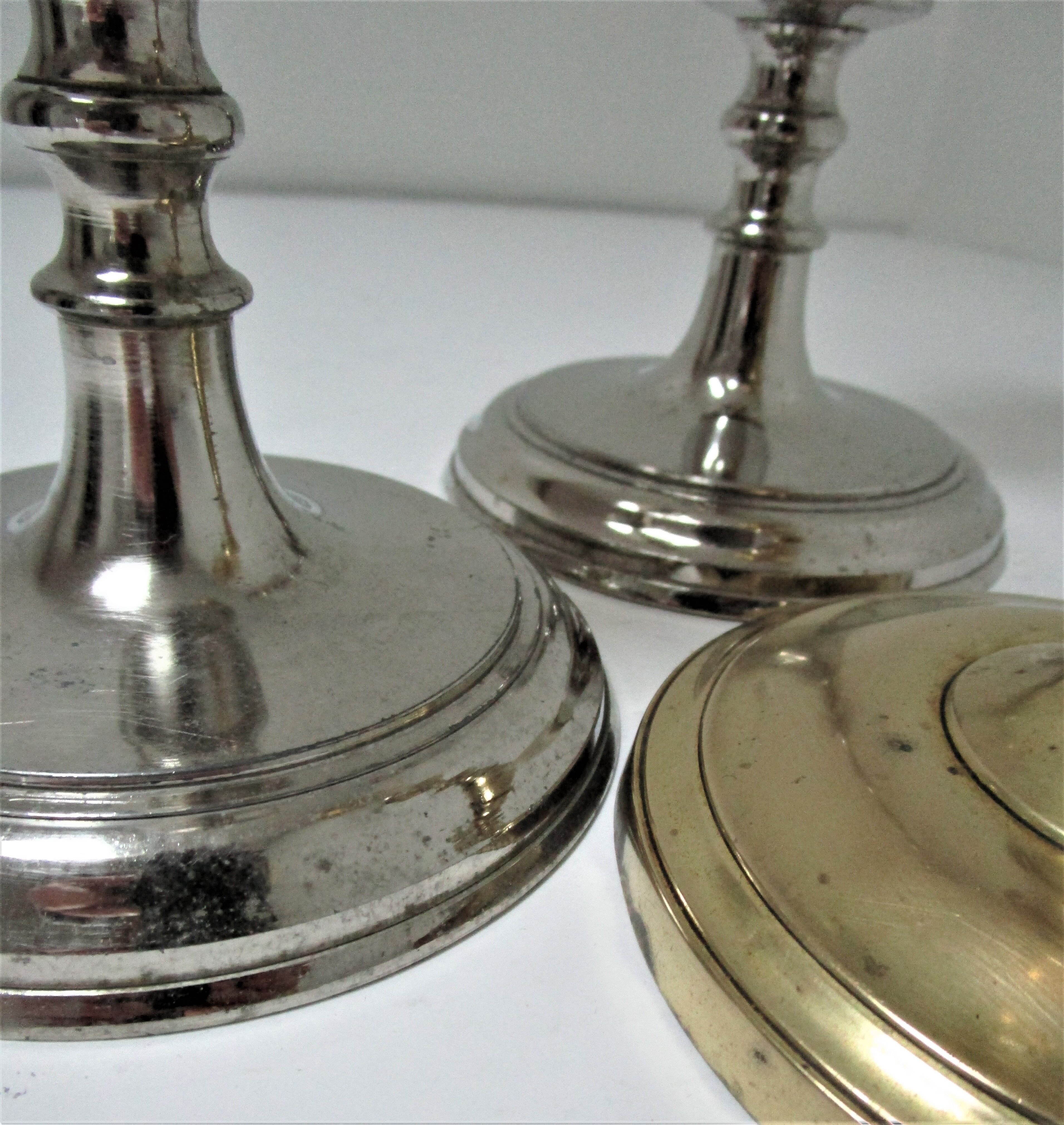 three brass and chrome candle holders early twentieth century