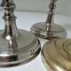 three brass and chrome candle holders early twentieth century