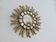 Golden wooden sun mirror with inlays from the early 20th century.