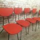 Lot of 6 red chairs in faux leather metal compass feet