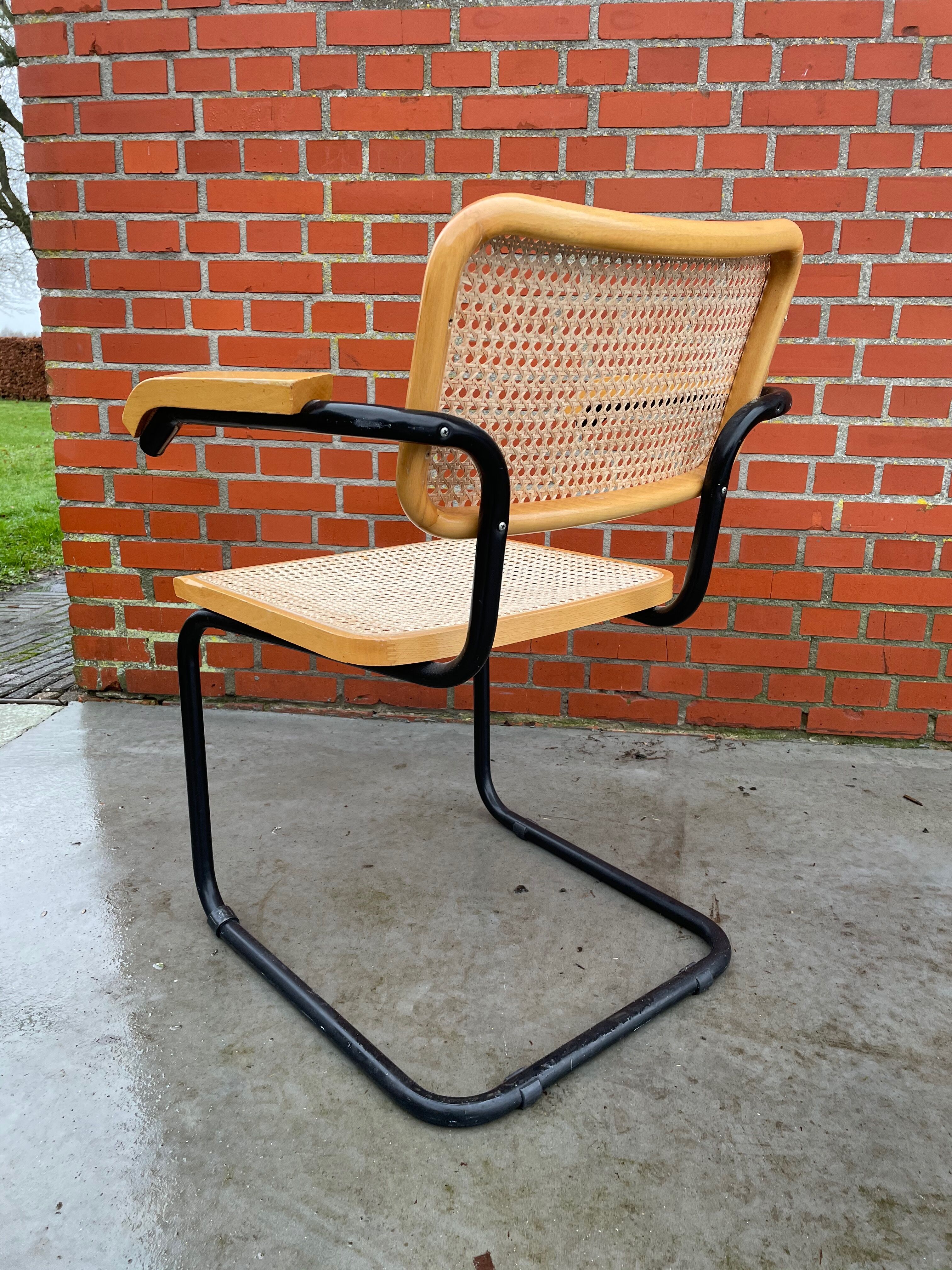 Cesca model chair designed by Marcel Breuer with black-framed armrests