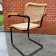 Cesca model chair designed by Marcel Breuer with black-framed armrests