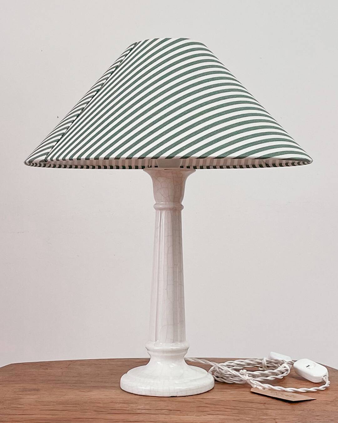 Earthenware lamp and striped lampshade