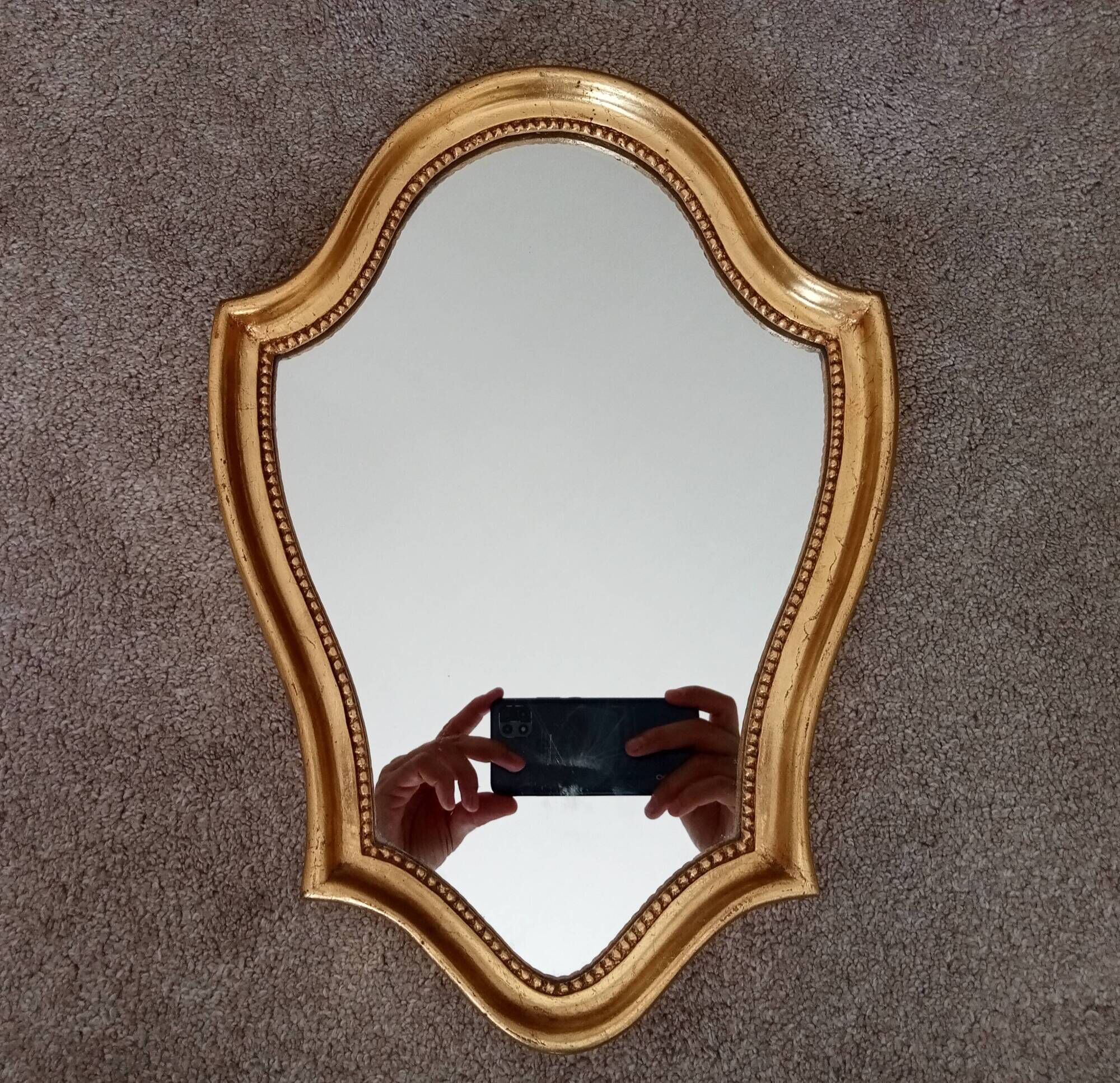 Vintage baroque mirror in gilded wood in the Louis XV style.