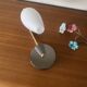 Swan neck wall light in brass and white opaline glass tulip.