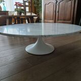 Round marble coffee table with tulip base.