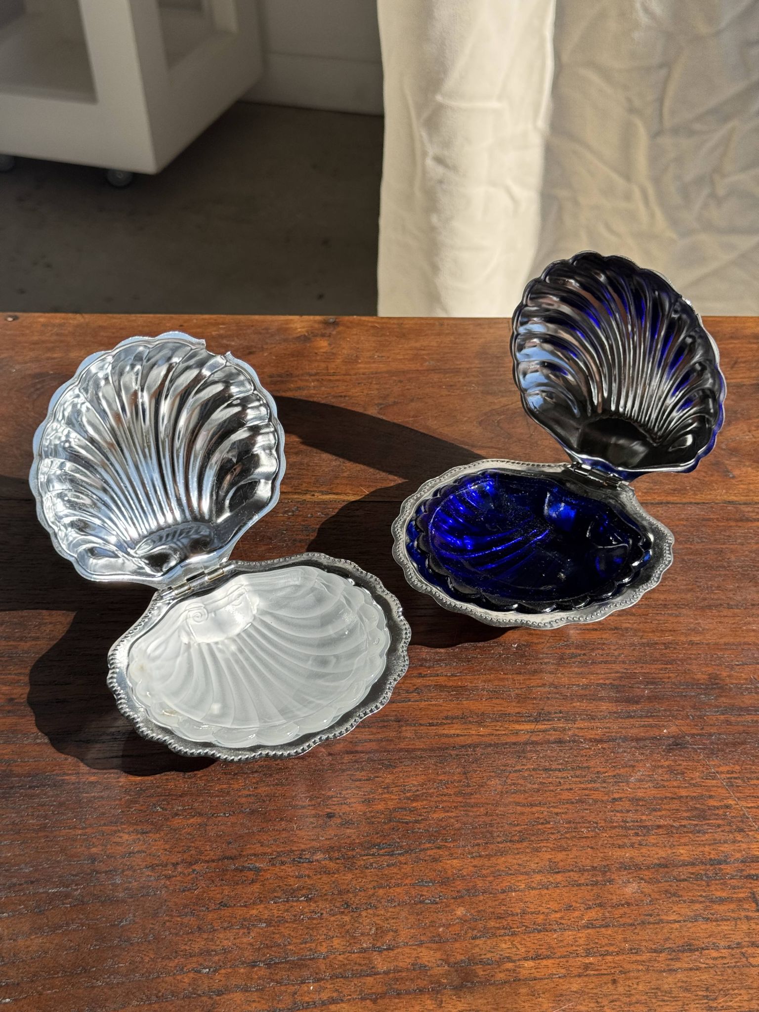 Vintage silver-plated shell butter dish with blue bowl.
