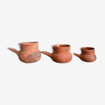 Trio of old terracotta pouring pots