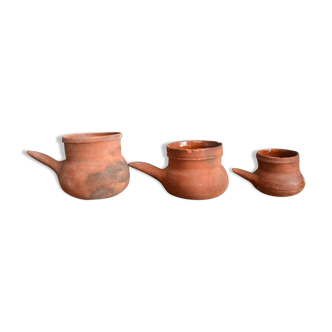 Trio of old terracotta pouring pots