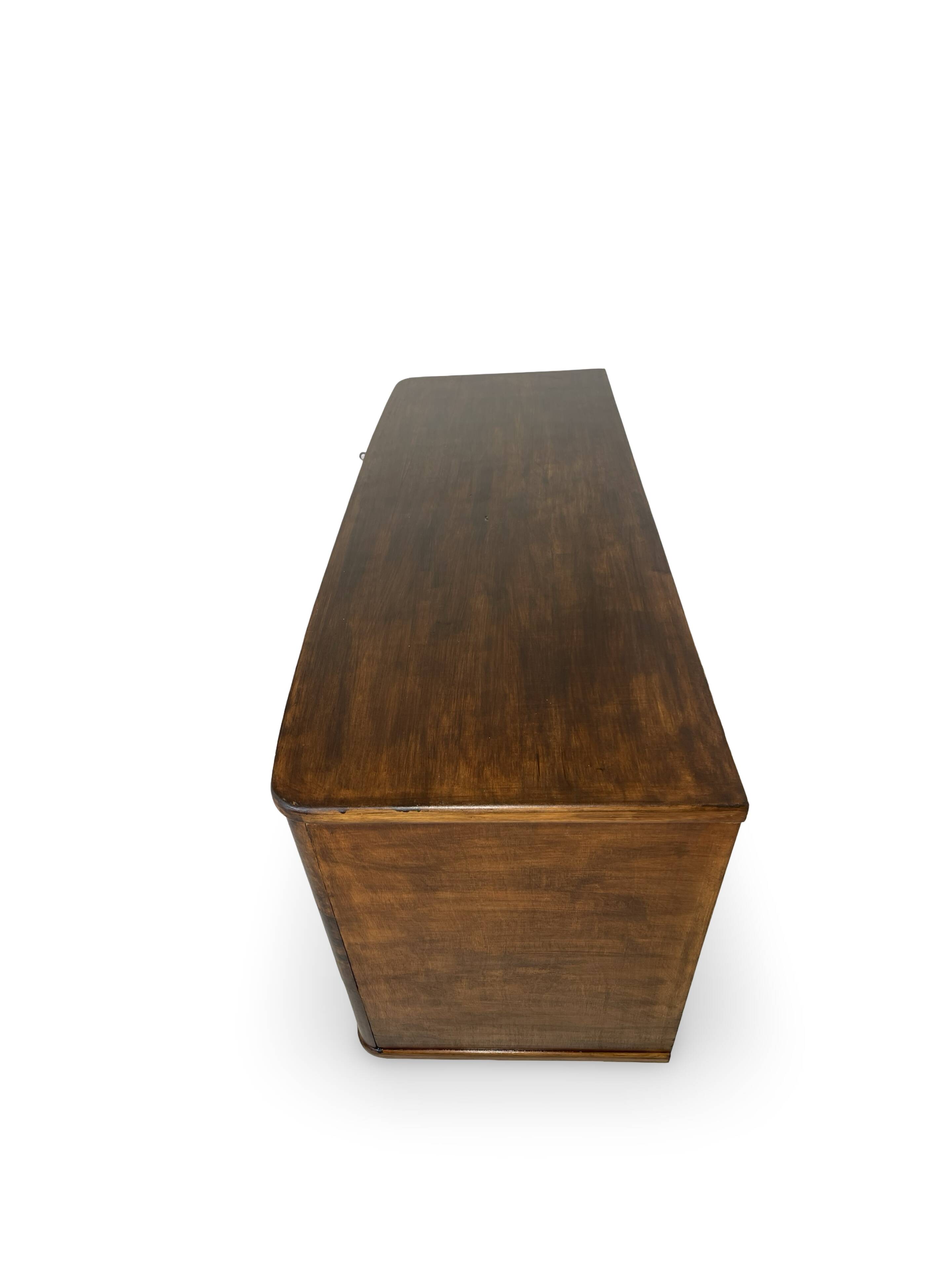 A vintage Italian chest of drawers, made of veneered walnut and solid wood,