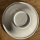 Small earthenware bowl from Italy, white with brown, green, and orange trim, D24.5.