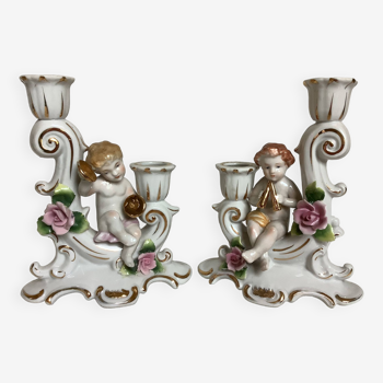 Pair of baroque candlesticks with musical cherubs