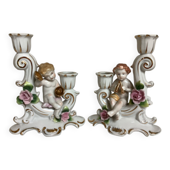 Pair of baroque candlesticks with musical cherubs