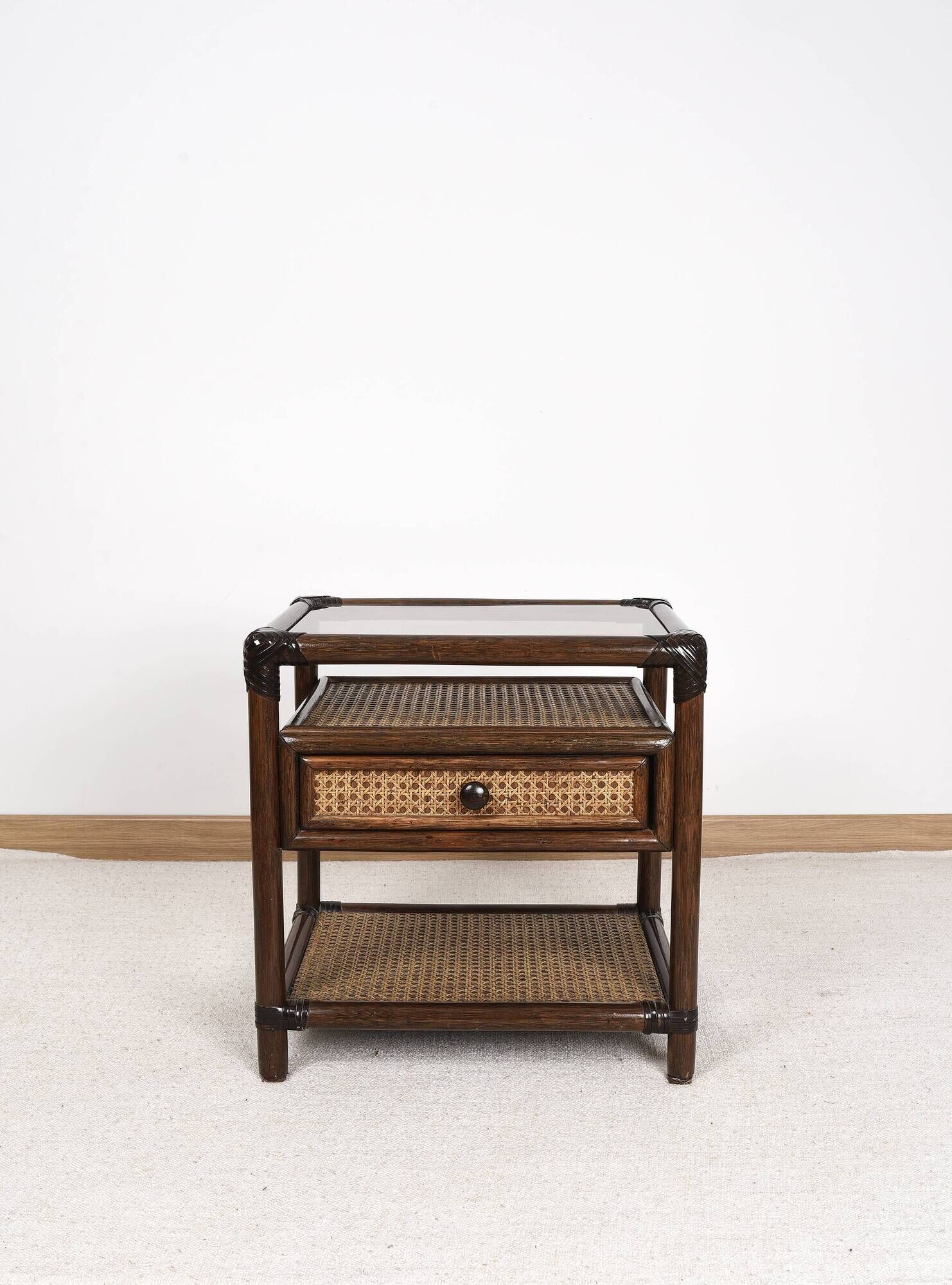 Rattan and cane bedside table, smoked glass top