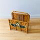 Vintage rattan magazine holder with floral decoration