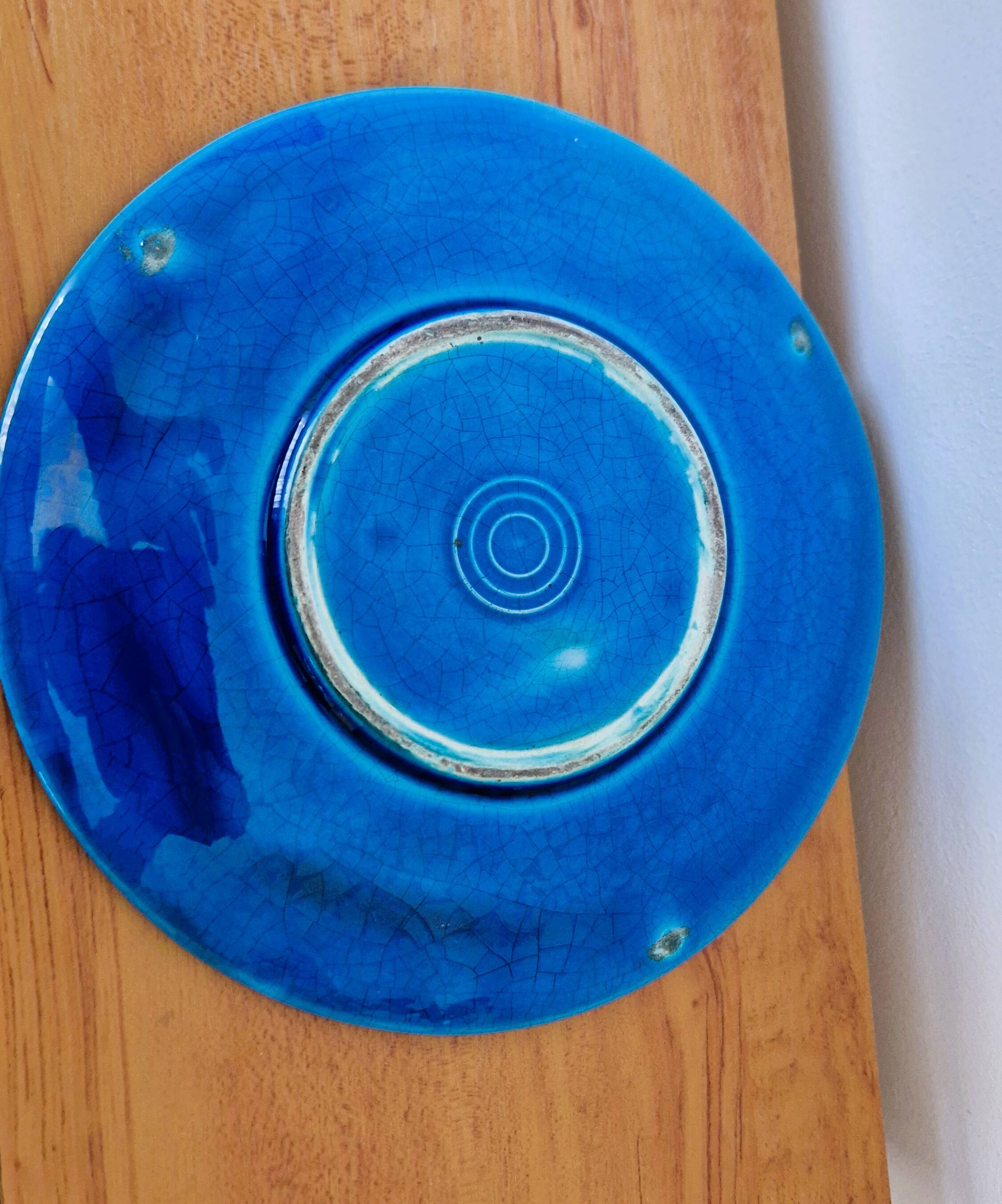 Blue ceramic soup tureen and crackled finish trivet.